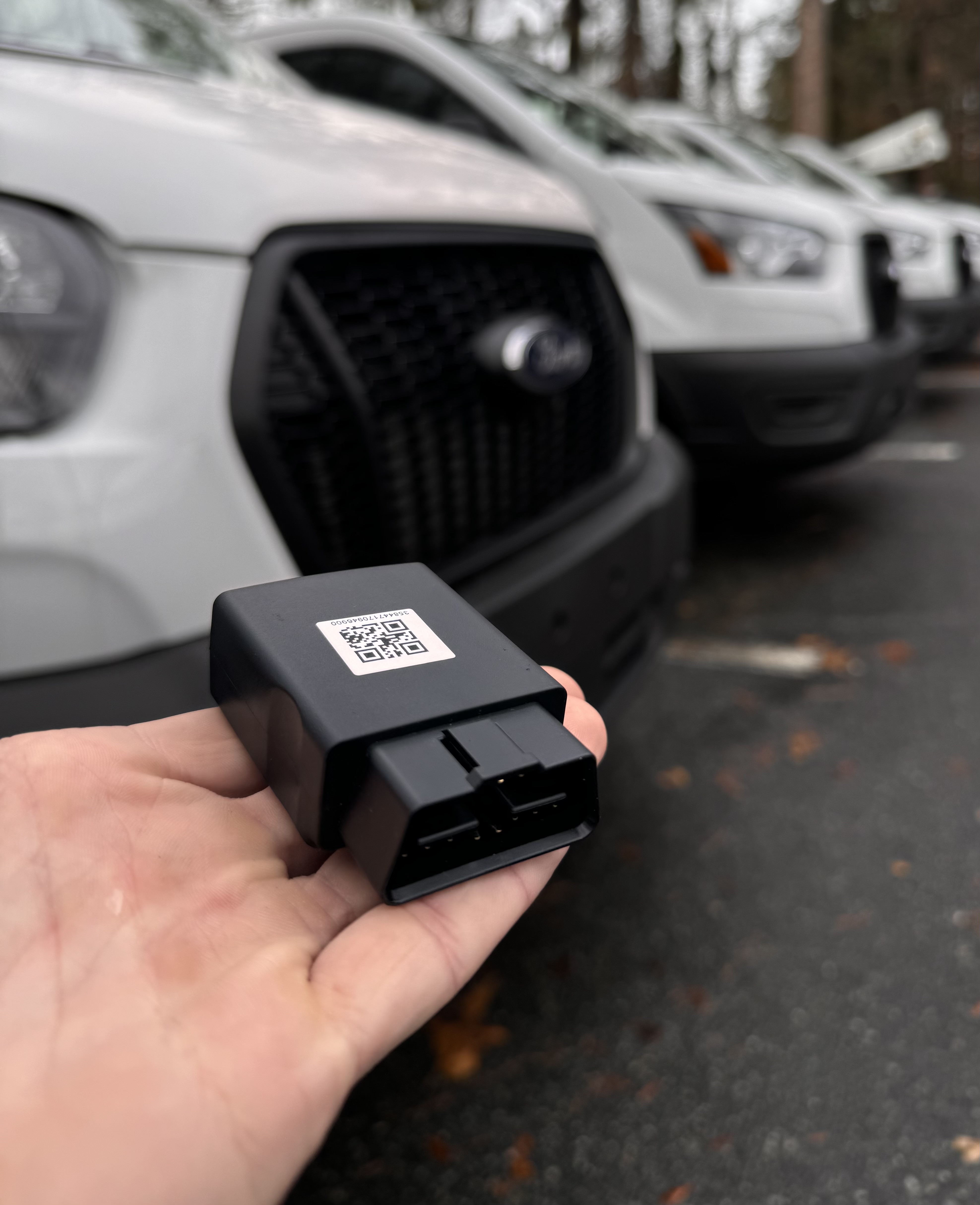 GPS tracker with service vehicles in the background